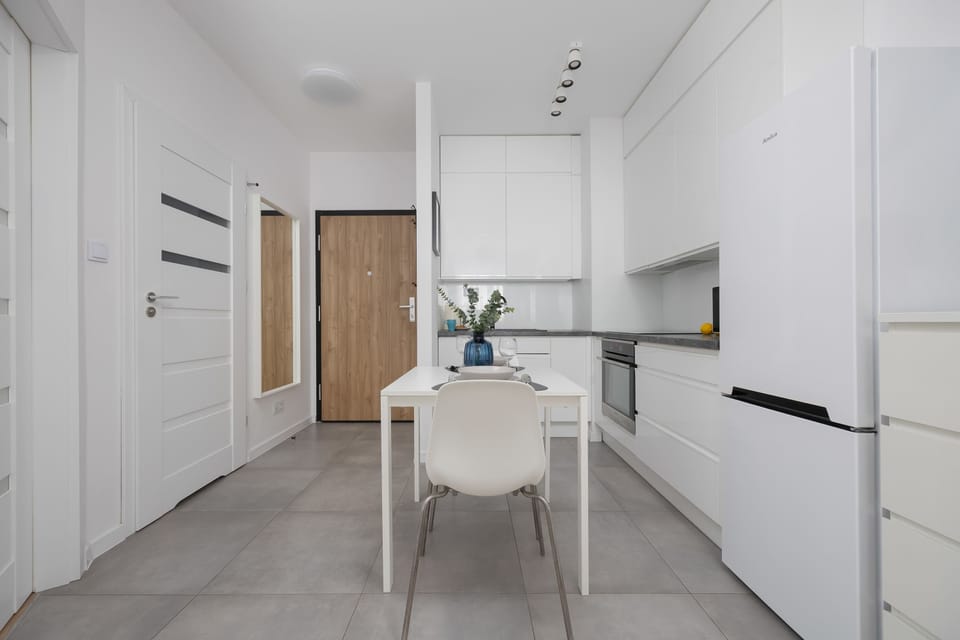 The sleek design of the kitchenette blending seamlessly with the living area.