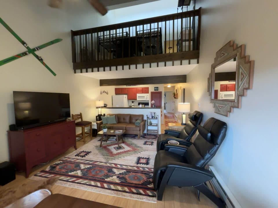 An overall view from the glass windows showing soaring ceilings and furnishings.