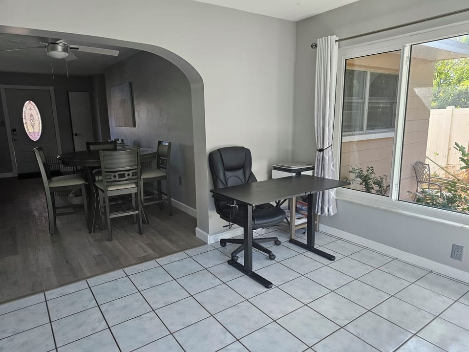 large open office space with lift desk, printer, large windows to bird watch.