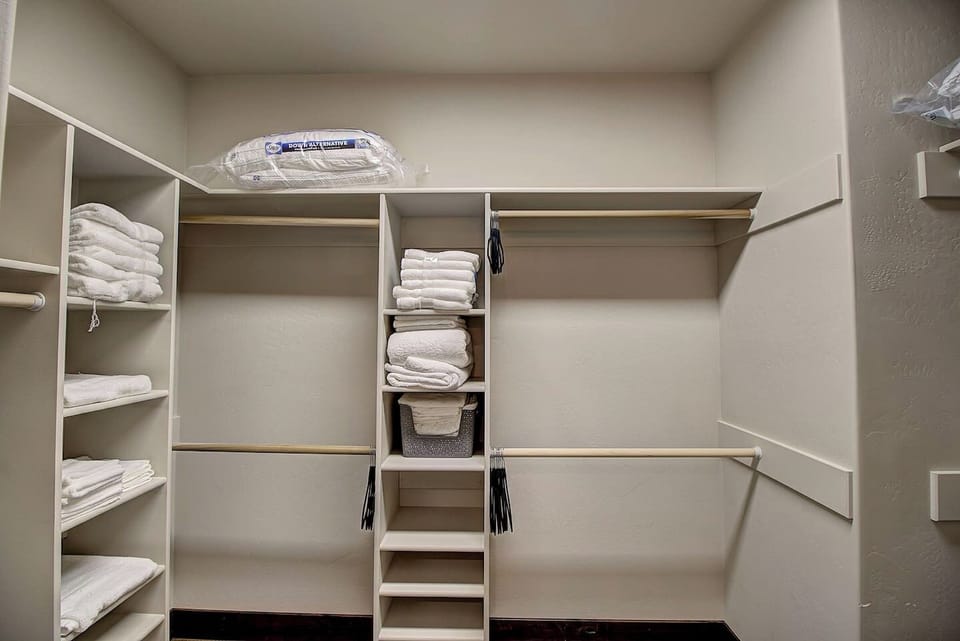 Spacious walk-in closet with ample shelving, fresh linens, and plenty of storage to keep your stay organized and comfortable.