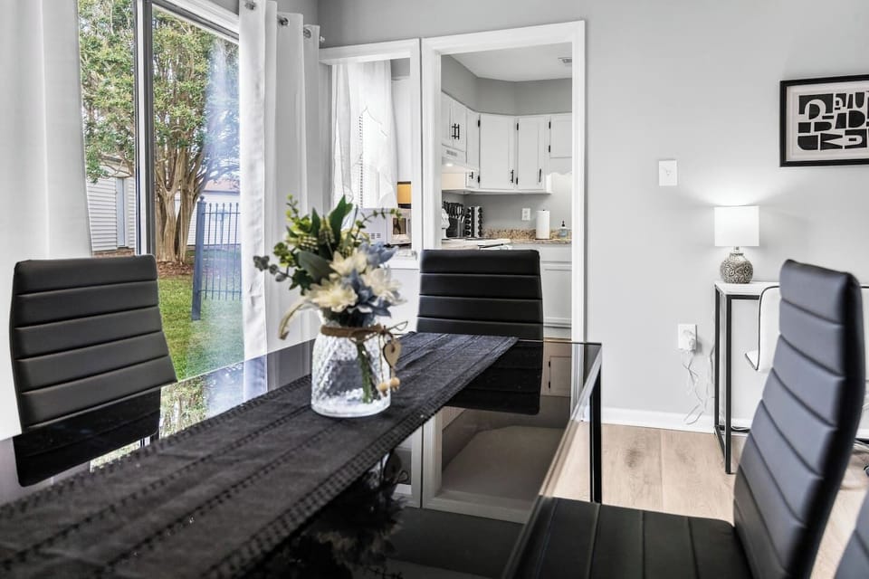 Sleek modern dining table with comfortable padded chairs for relaxed gatherings.