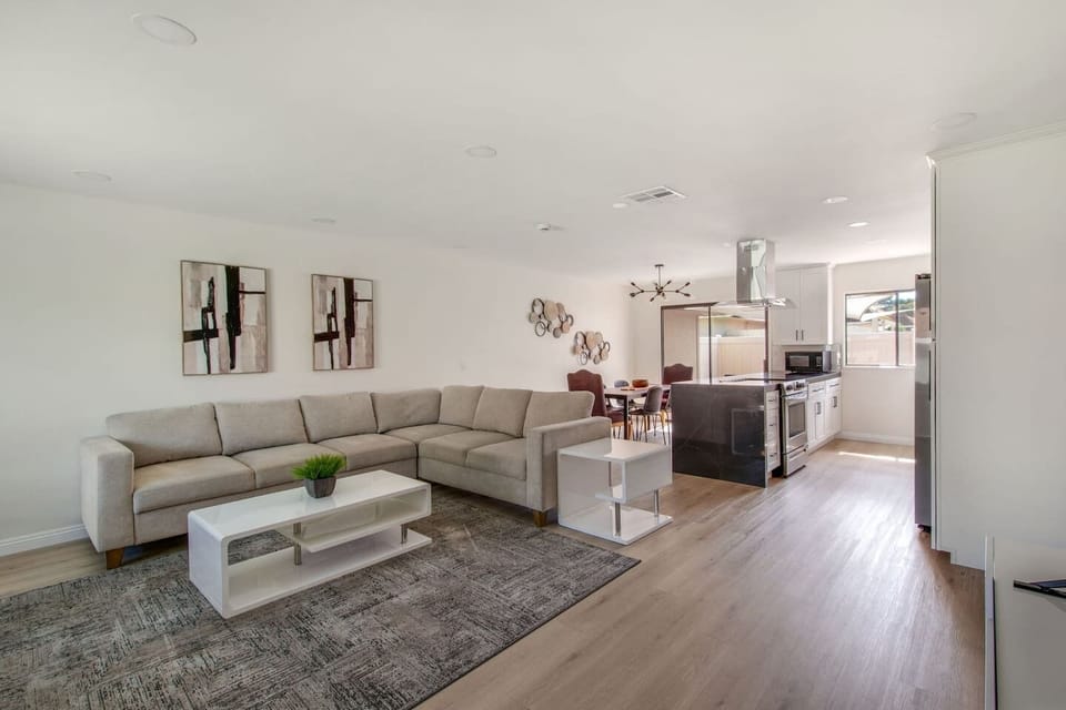 Bright open-concept living area with a comfortable sectional for movie nights