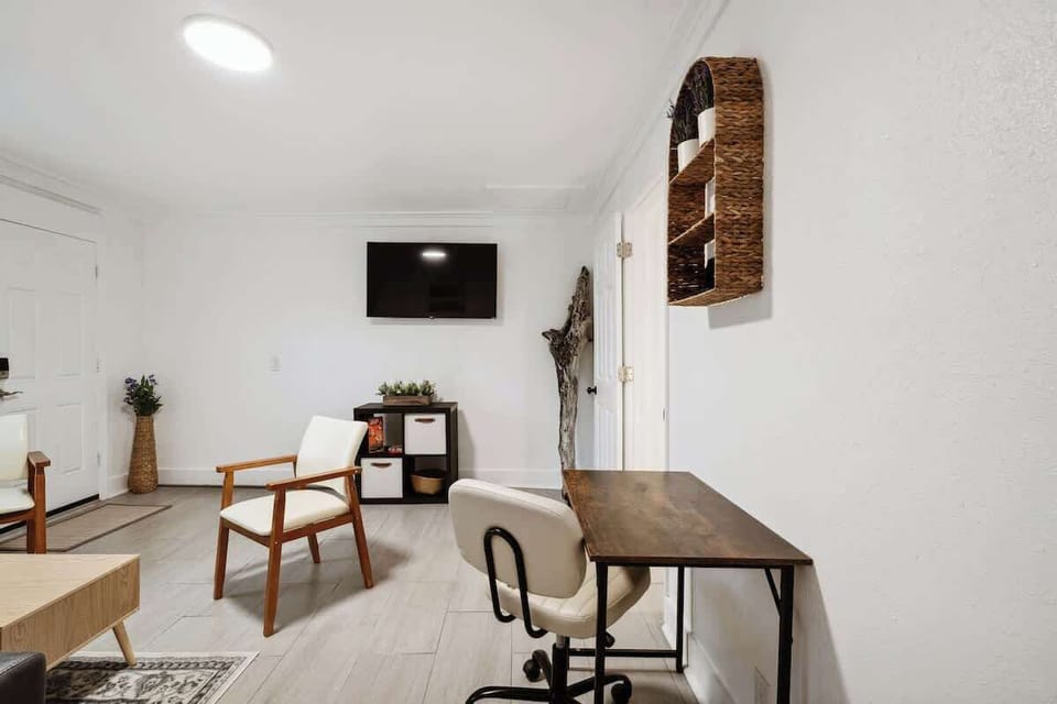 Open living area w/ TV & desk space for relaxing or catching up on work