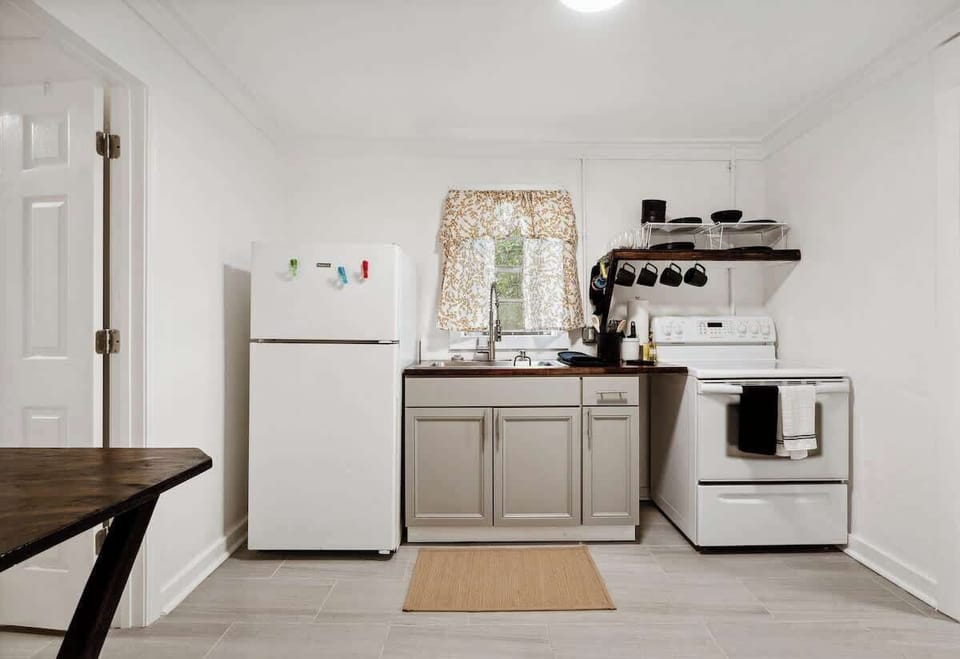 Kitchen w/ clean countertops, stove & organized setup for easy cooking