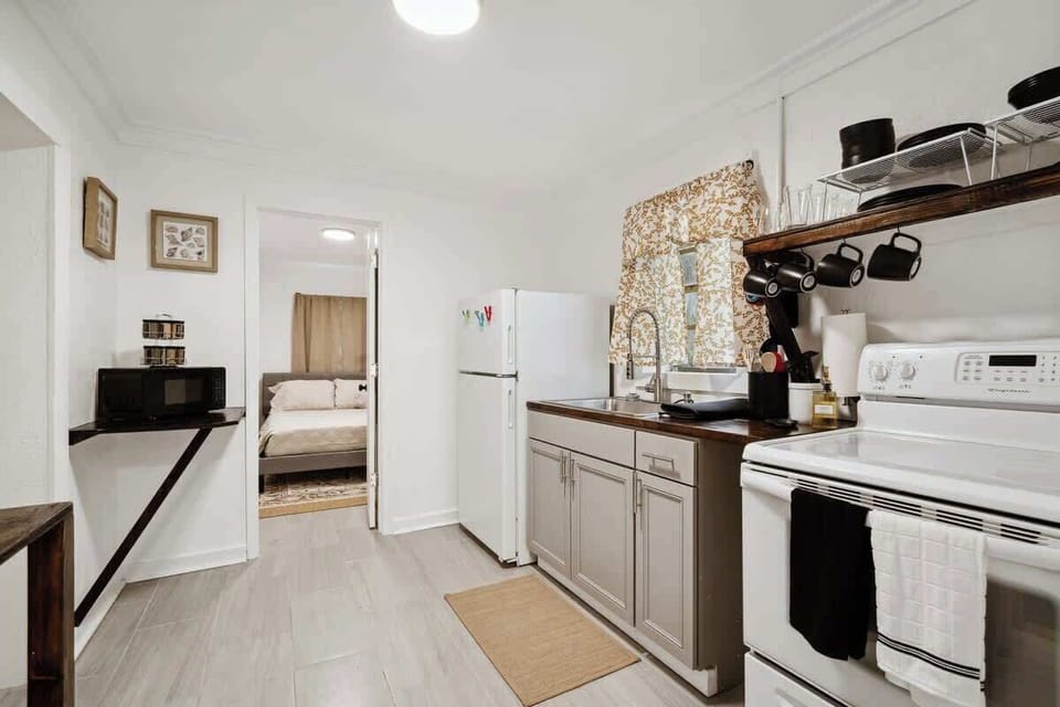 Fully equipped kitchen w/ stove, fridge & compact layout for easy meal prep