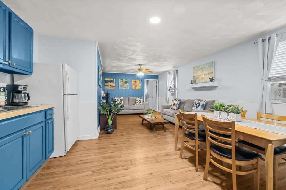 Open layout with a full dining table set beside the kitchen. Great for enjoying meals together or planning your day’s adventures.