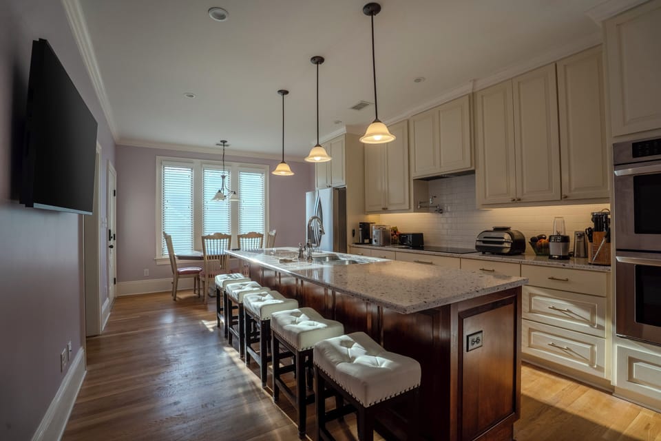 The main gourmet kitchen offers double ovens, double dishwashers, thoughtful prep space, and a beautiful setting for group meals and hospitality.