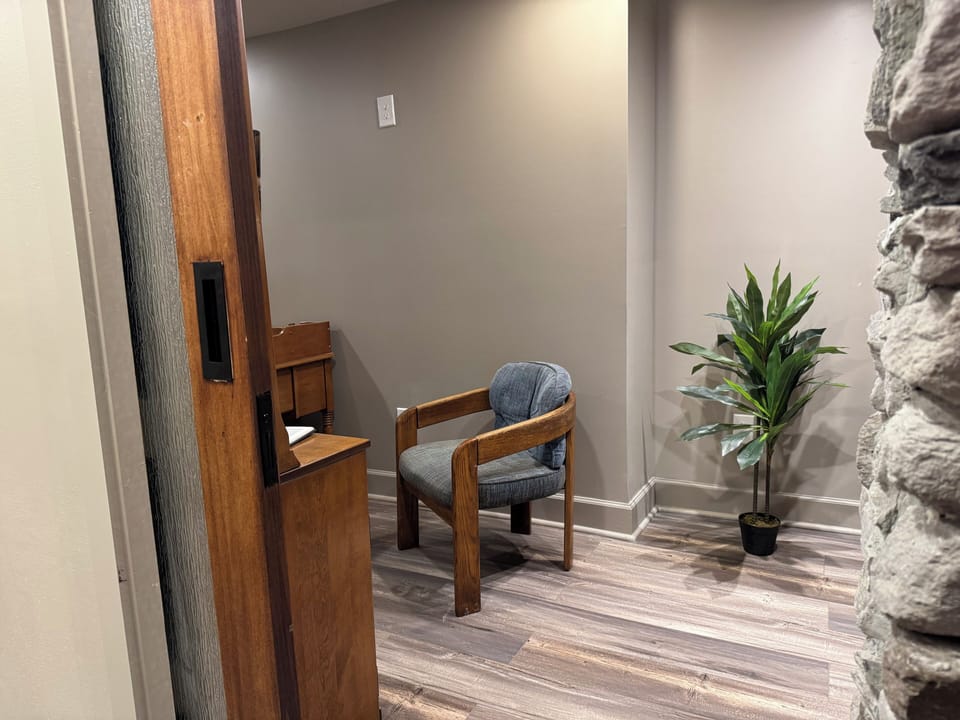 Beyond the see-through fireplace, a private office offers a quiet, inviting place for remote work, planning, reading, or reflection.