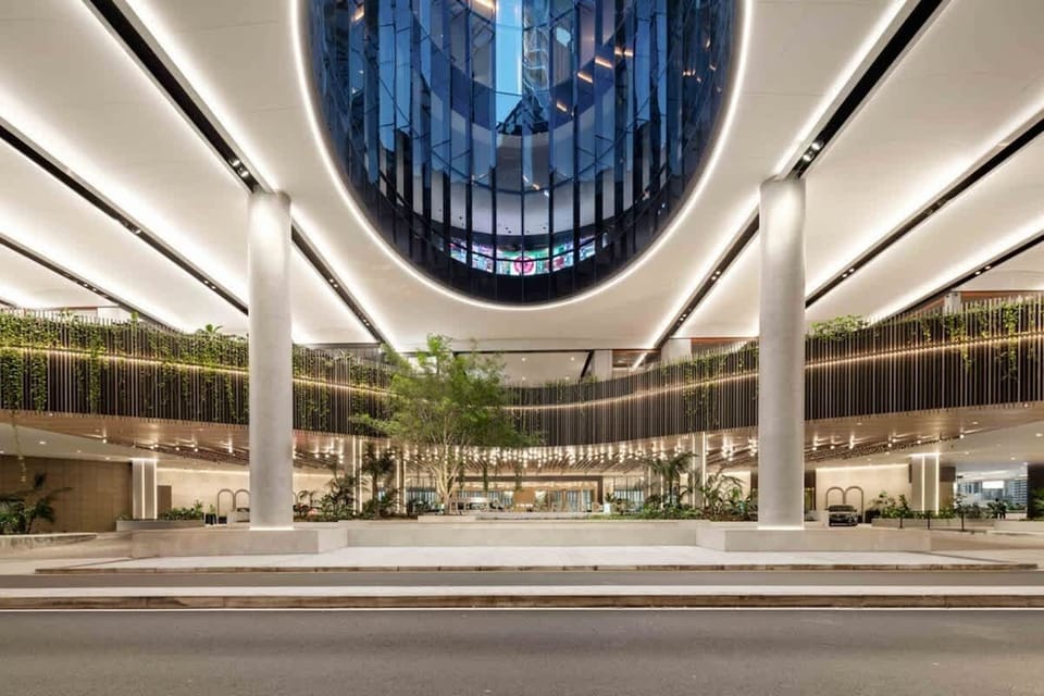 Grand covered entryway with lush landscaping and striking architectural design for a five-star welcome.