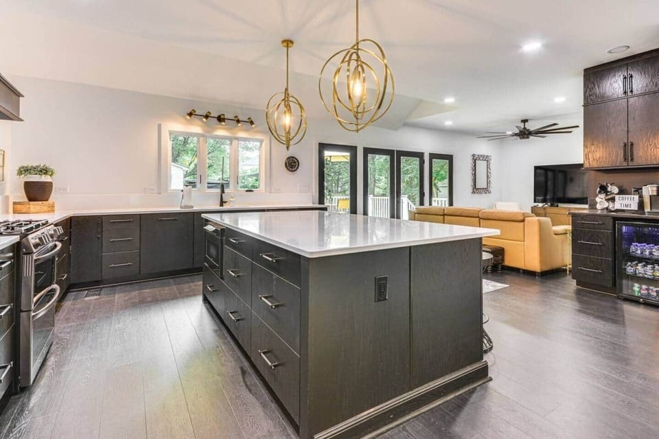 Spacious kitchen with an island, a coffee station with a mini refrigerator.
