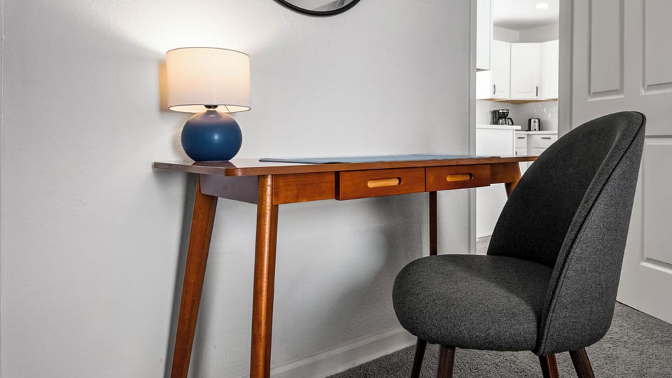 Dedicated workspace with desk and lamp - ideal for remote work.