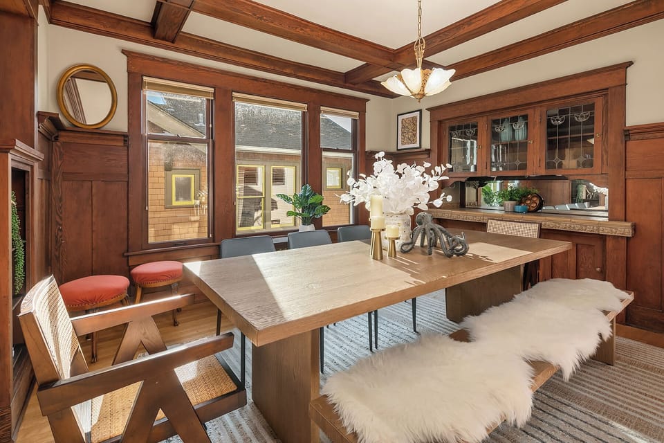 Sunlit dining area with classic woodwork and modern accents.