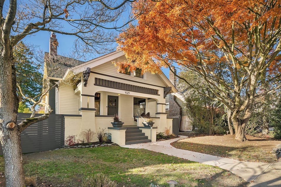 Classic Seattle craftsman framed by mature trees.