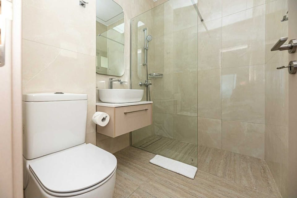 Shower, hair dryer, slippers, towels