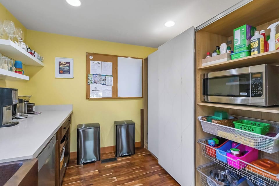 Microwave; Supply cabinet and trash/recycling.