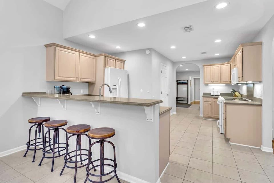 Your spacious kitchen invites culinary adventures with modern appliances and a breakfast bar where you can sip morning coffee.