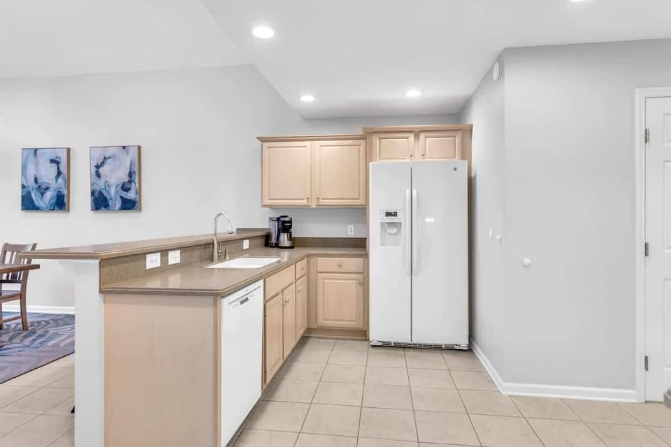 Your spacious kitchen features modern appliances, ample counter space, and sleek cabinetry—perfect for preparing meals during your stay.