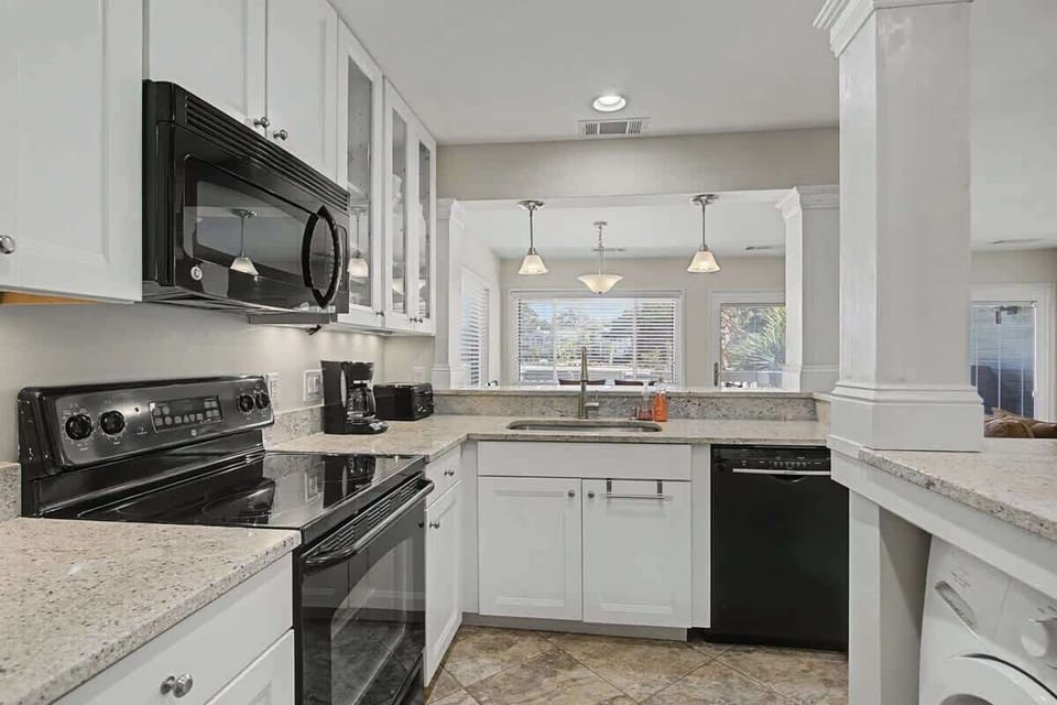 Whip up your favorite meals in this bright, fully-equipped kitchen with granite counters and modern appliances.