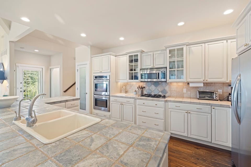 Bright kitchen with expansive quartz counter space
