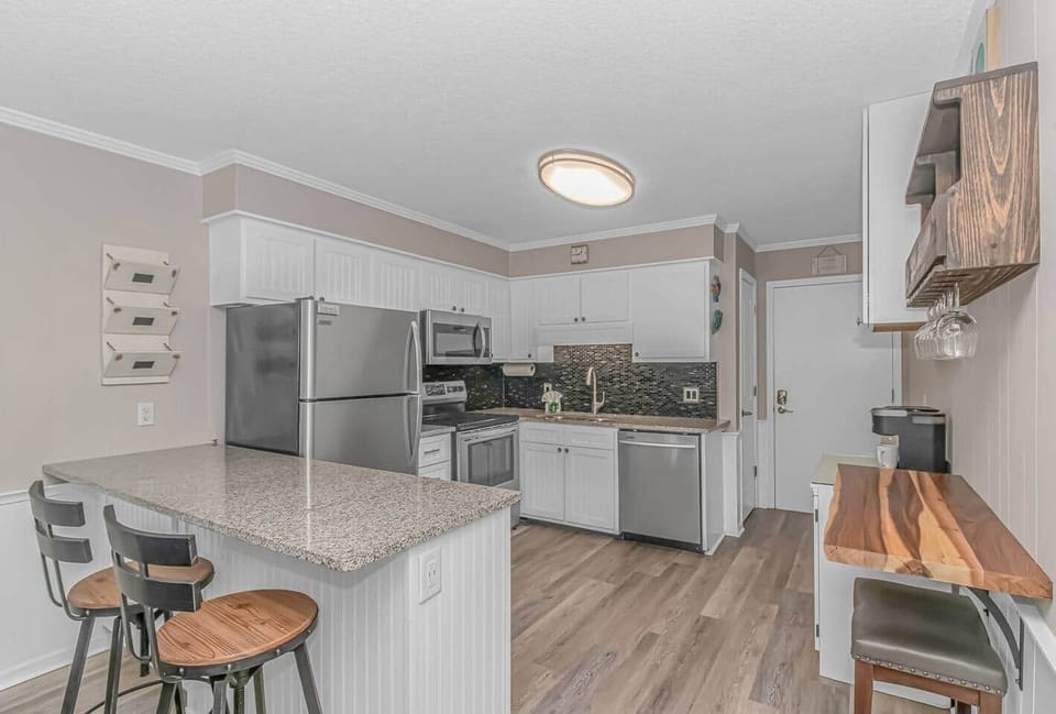 Newly renovated kitchen boasts top-of-the-line stainless steel appliances, granite countertops, and fully stocked with everything you need to cook and serve meals!