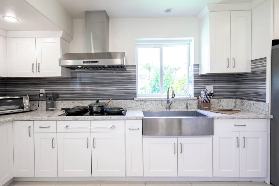 Bright modern kitchen with stainless steel appliances and granite counters.