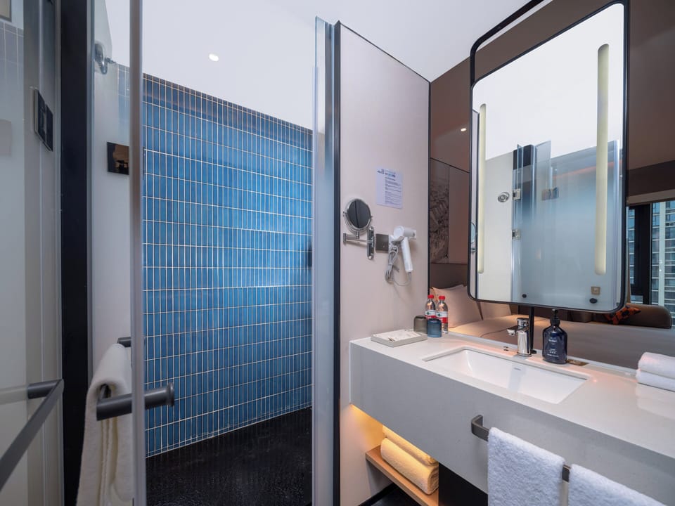 Shower, designer toiletries, hair dryer, slippers