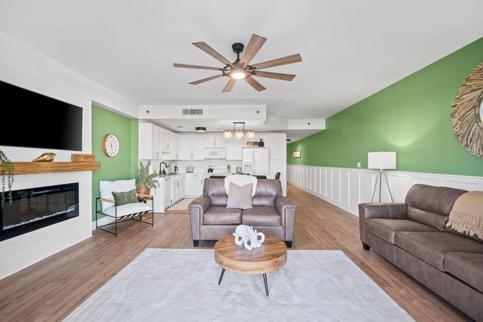 The living room is a spacious and welcoming retreat, thoughtfully designed with an open floor plan that flows seamlessly into the kitchen—perfect for gathering, entertaining, or simply relaxing in style.