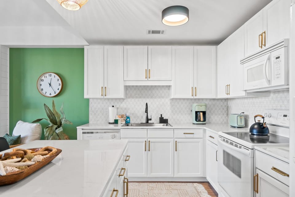 The kitchen is both functional and inviting, thoughtfully equipped with all the essentials for a comfortable stay—from cookware and utensils to small appliances that make meal prep a breeze.
