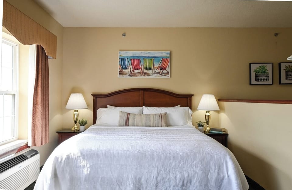 Drift off under crisp linens and calming bedside lamps.