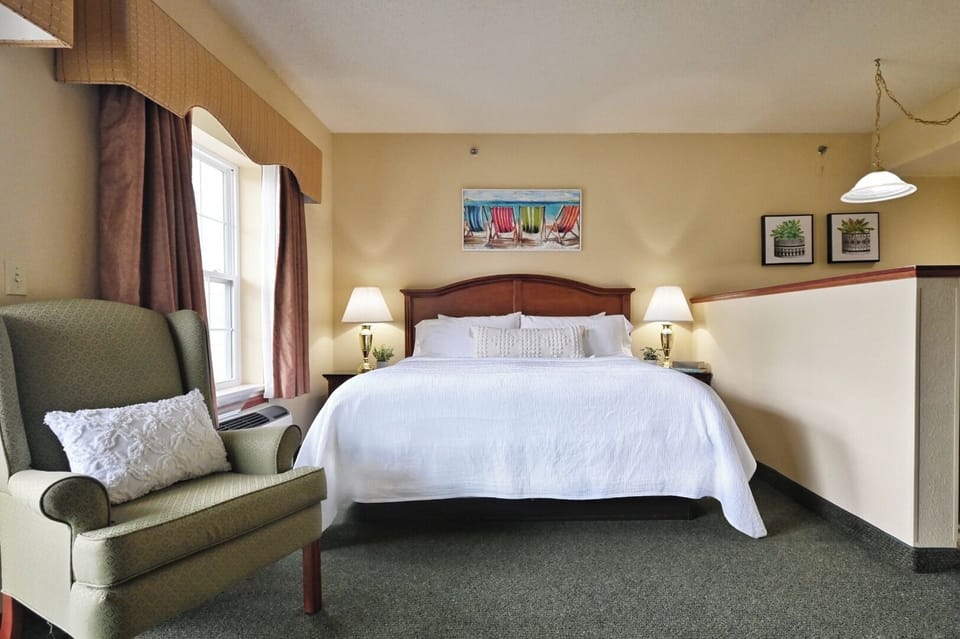 Sink into a plush king bed with warm bedside glow.