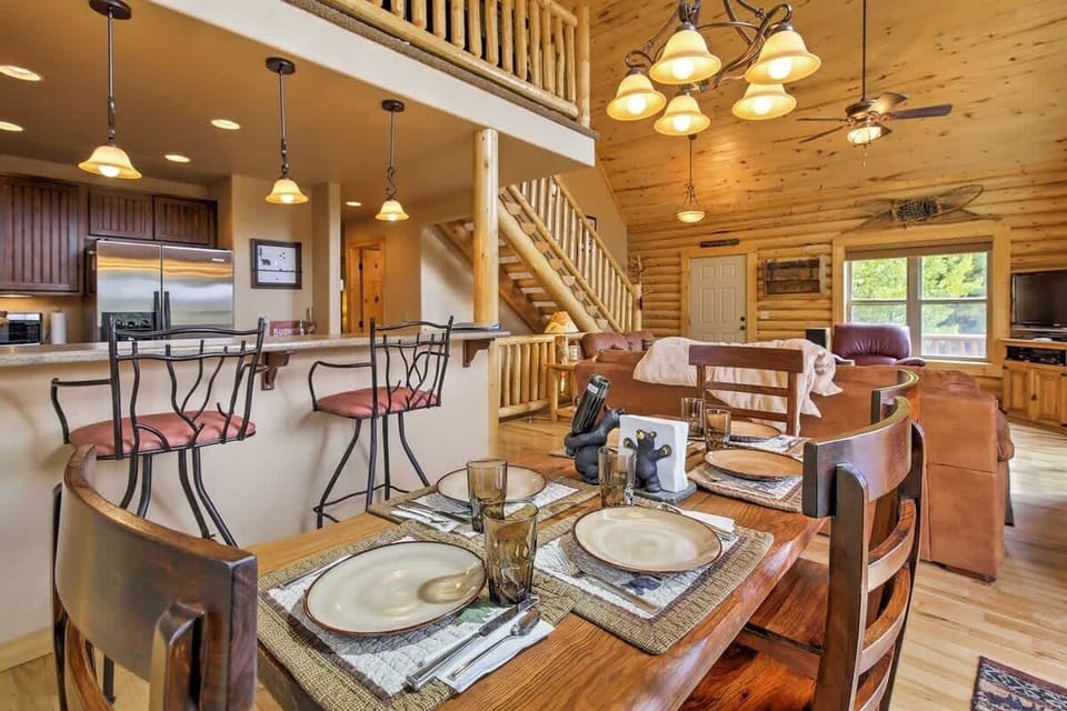 Open-concept dining area with a view of the kitchen and living room