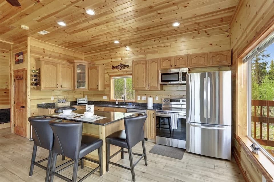 Open kitchen and living space with natural light and scenic views