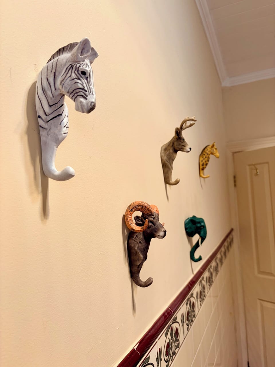 Quirky animal wall hooks a small detail that adds charm to the bathroom.