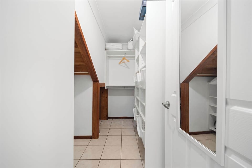 The walk-in wardrobe provides ample room to unpack fully, keeping the primary suite calm and clutter-free.