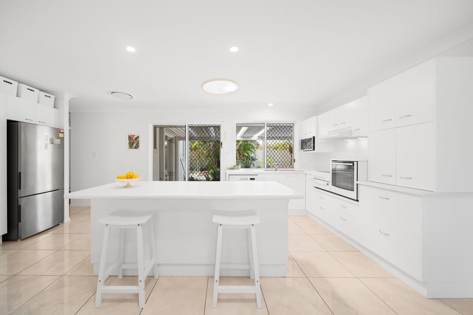 The kitchen delivers effortless meal preparation with an expansive island, quality appliances and a bright layout that encourages easy cooking together.