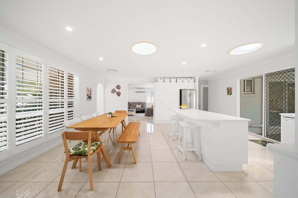 The dining area creates a lovely setting for shared meals overlooking the garden and the pool.