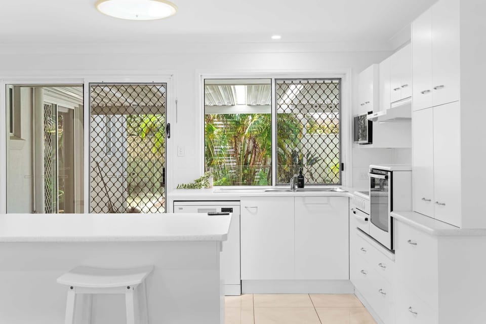 Contemporary kitchen overlooking the pool and outdoor area.