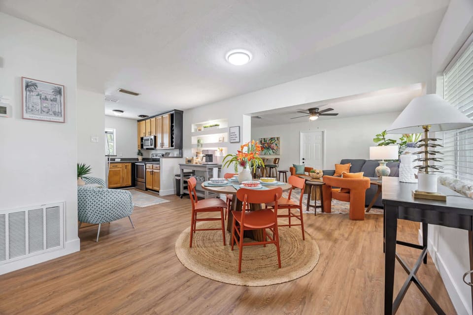 Open-concept living and dining area with modern kitchen and vibrant seating.