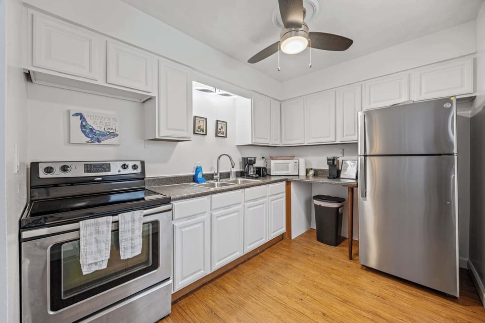 Modern kitchen with stainless steel appliances and white cabinetry