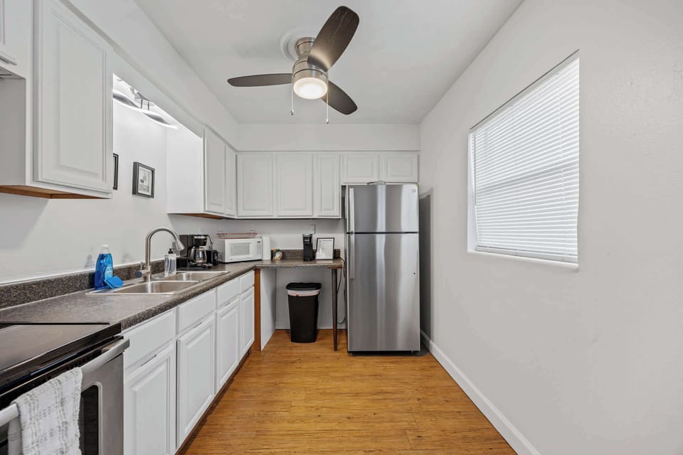 Modern kitchen with stainless steel appliances and white cabinetry