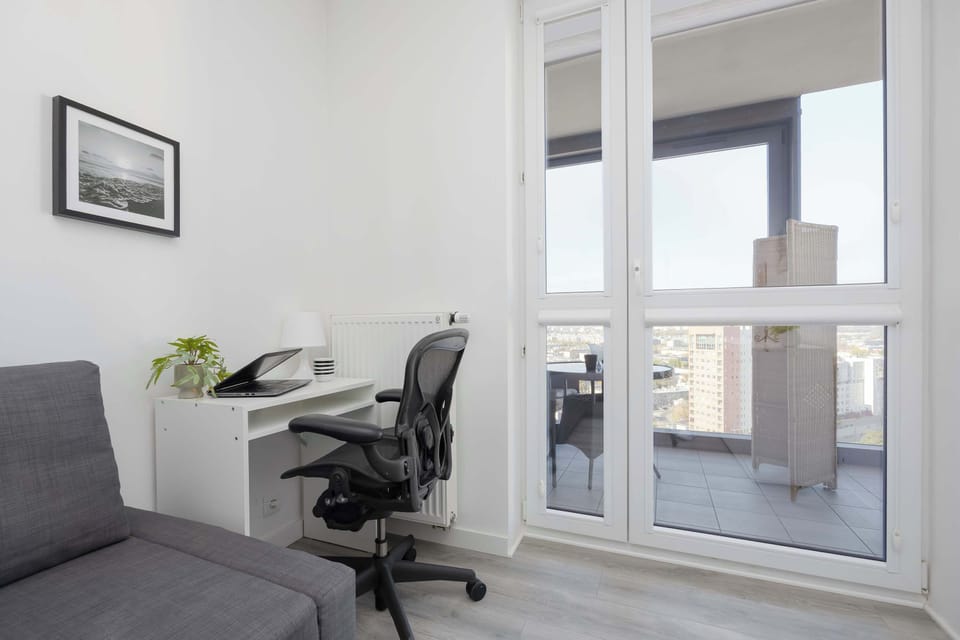 Bright workspace with a desk and city view.