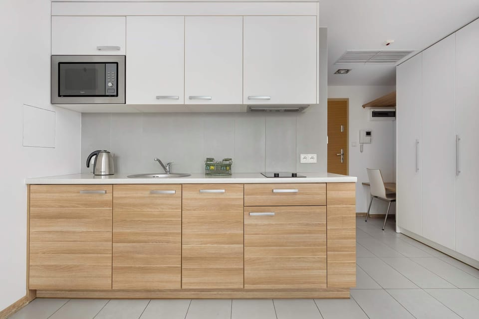 The sleek design of the kitchenette blending seamlessly with the living area.
