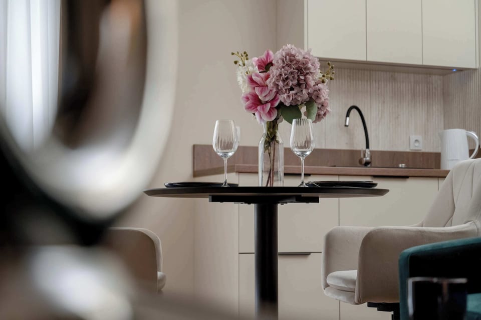 Dining table with flowers adding a touch of elegance to the space.