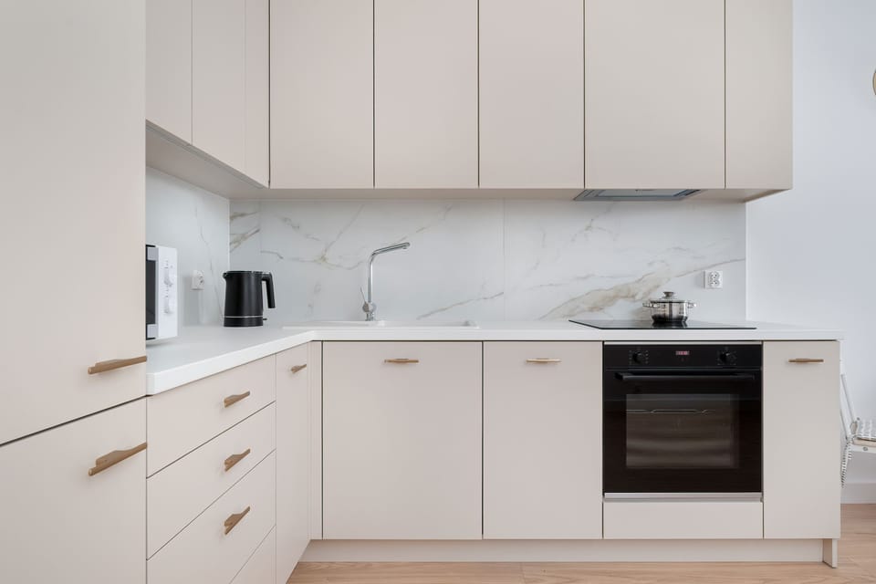 A modern kitchen with marble finishes and a functional layout makes everyday meal preparation effortless.