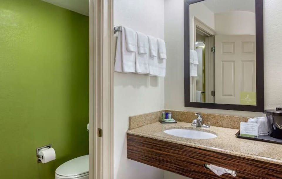 Freshen up at the bright vanity with plush towels.