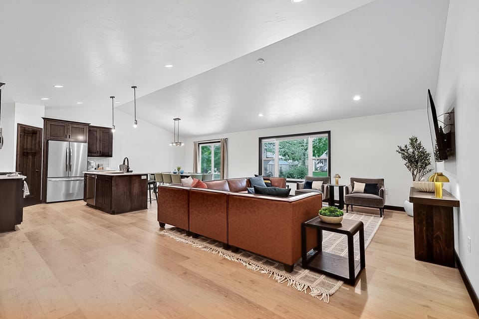 Step inside this stunning new build just 3 houses from Lambeau Field! The open-concept living room, dining area, and kitchen feature modern finishes, stylish décor, and plenty of space to relax or entertain before and after the big game.
