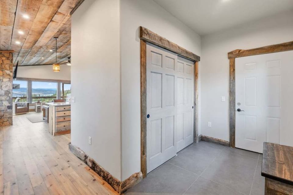 Rustic beams and modern comfort blend beautifully in this welcoming entryway at 128 GCR 4034, leading to your mountain retreat's open living spaces.