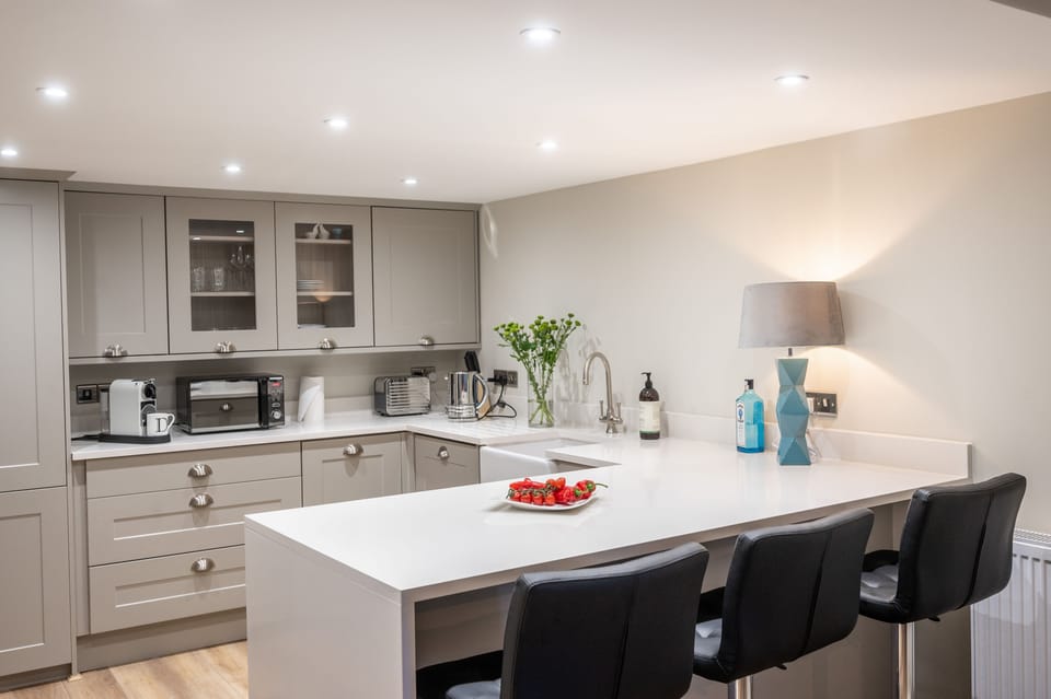 Ground floor: Kitchen with an electric Range style oven, dishwasher, washer/ dryer, microwave, Butler's sink, breakfast bar and coffee machine