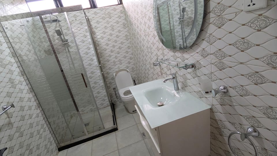 Shower, hair dryer, slippers, towels