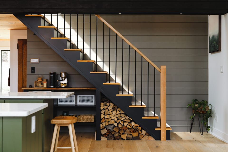 Stocked firewood under the stairs makes it easy to keep the stove going and enjoy those cozy lake house nights.